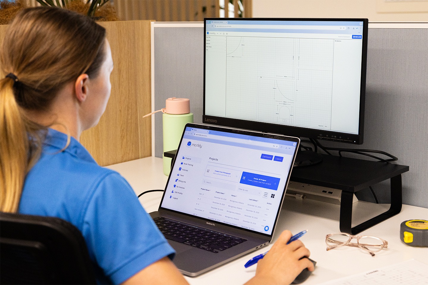 Person working on Moddy software at a desk with a dual-monitor setup